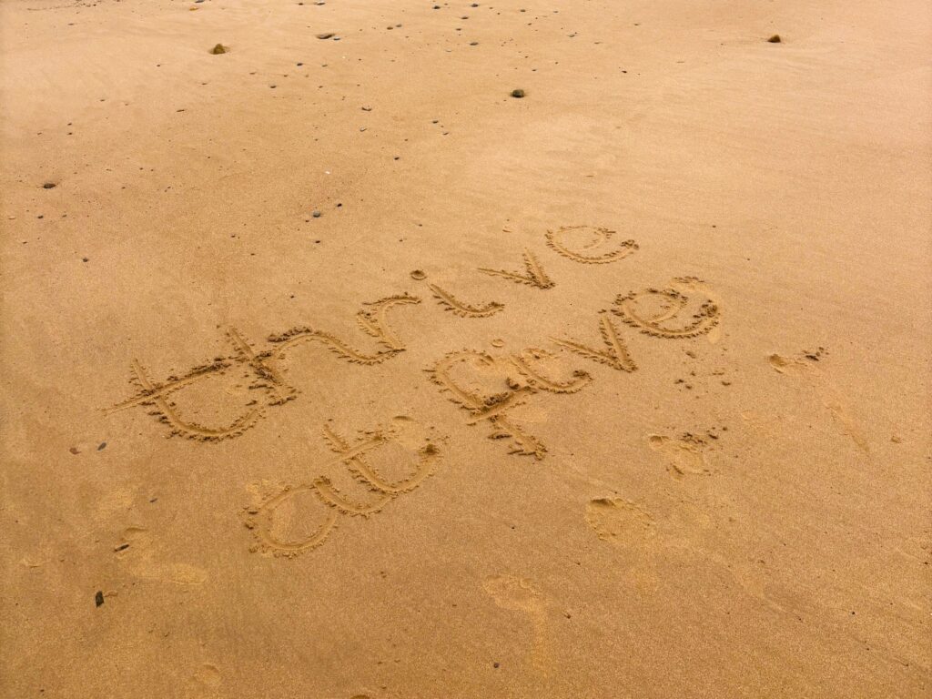 Thrive at Five logo written in sand